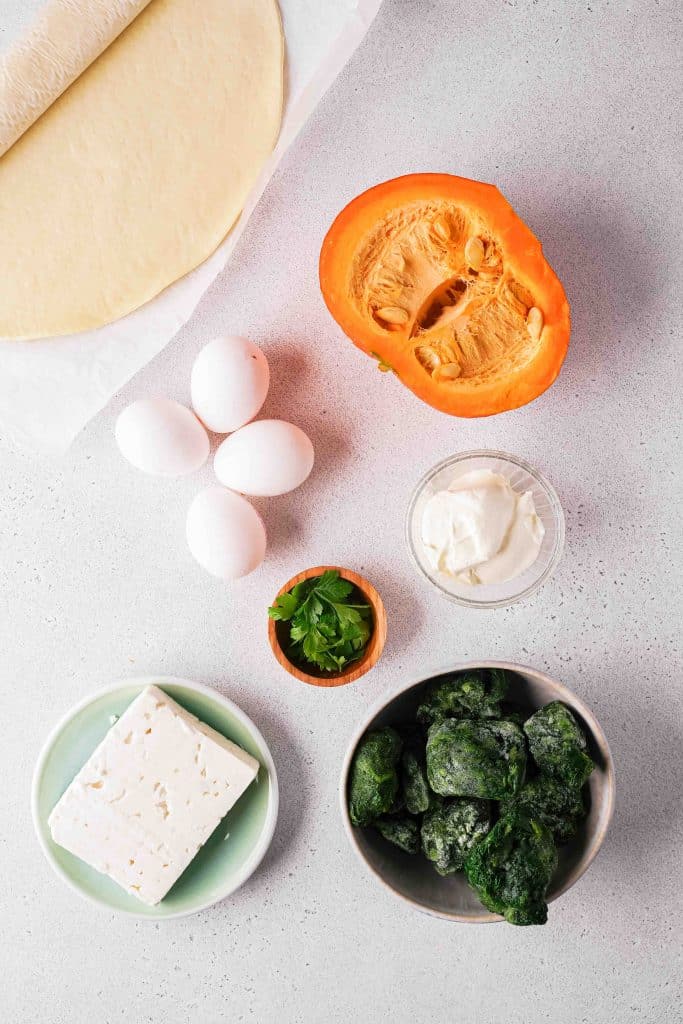 Ingredients to make a Roasted Pumpkin Quiche with Feta and Spinach 