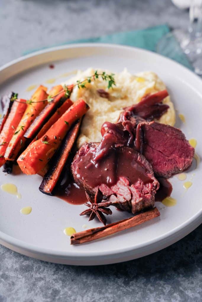 Zoom on a plate of beef tenderloin with red wine sauce for Christmas
