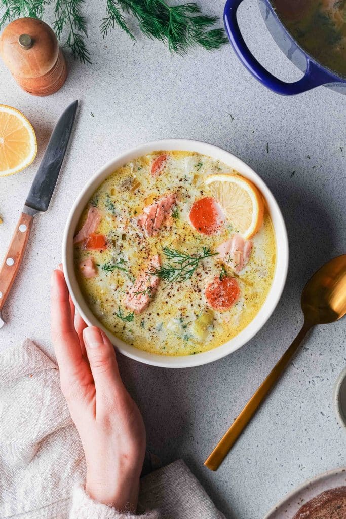 Zoom on a bowl of Finnish salmon soup with dill