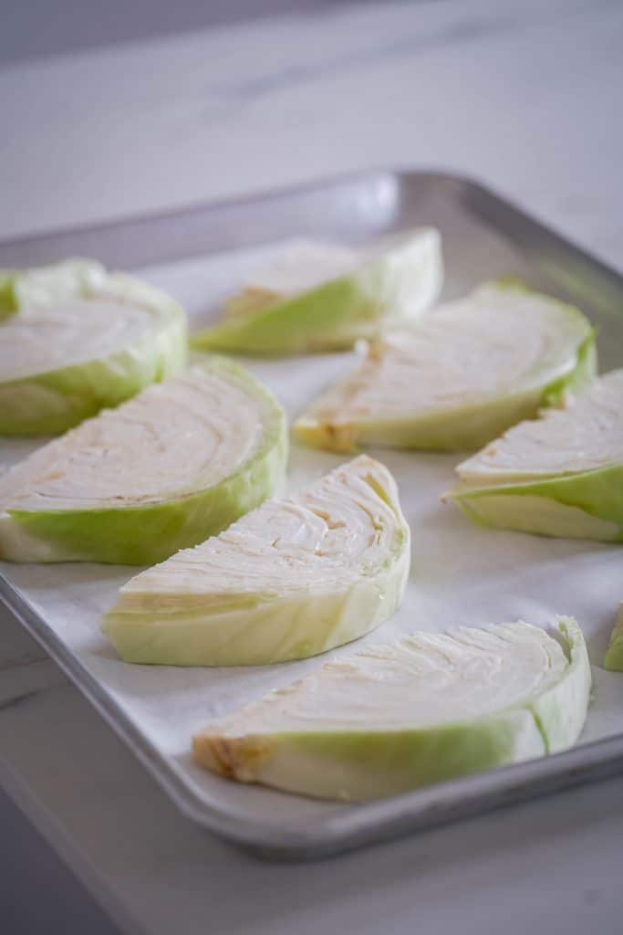 White cabbages wedges on a sheet pan