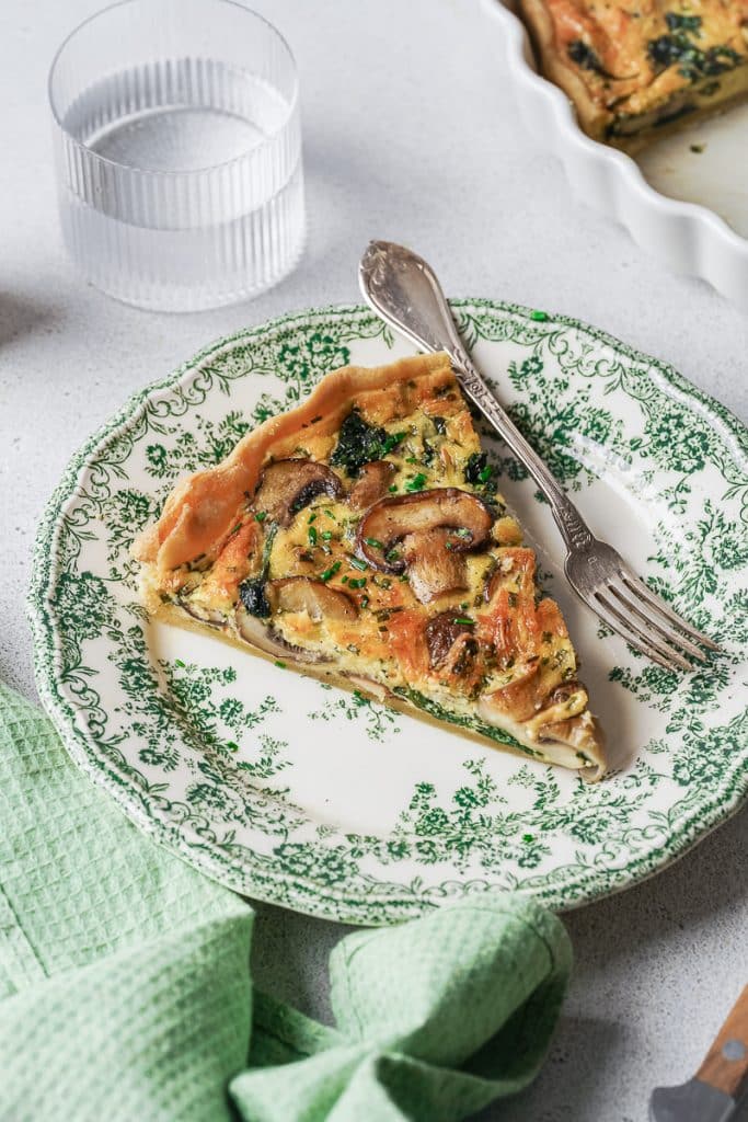 Zoom on a piece of a mushroom and spinach quiche