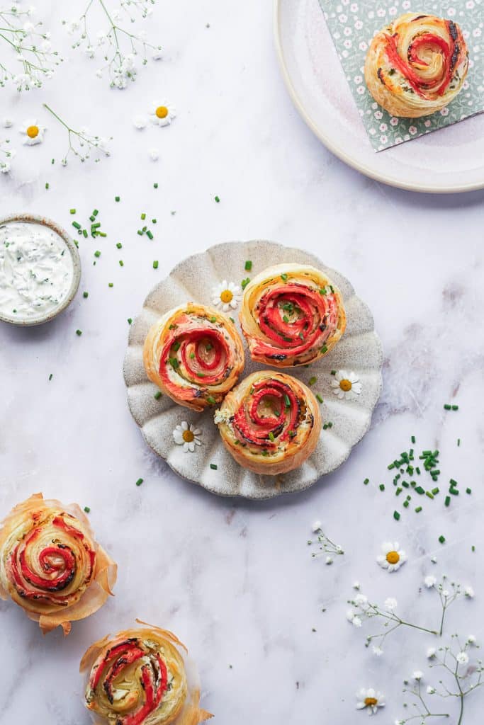 Zoom in on a plate with three smoked salmon roses seen from above