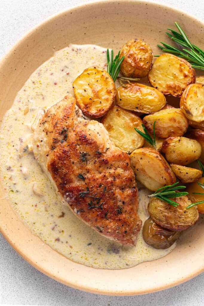 Creamy Dijon Mustard Chicken (poulet à la moutarde) with potatoes on a plate