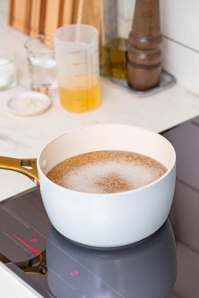 A pan containing mustard seeds being blanched.