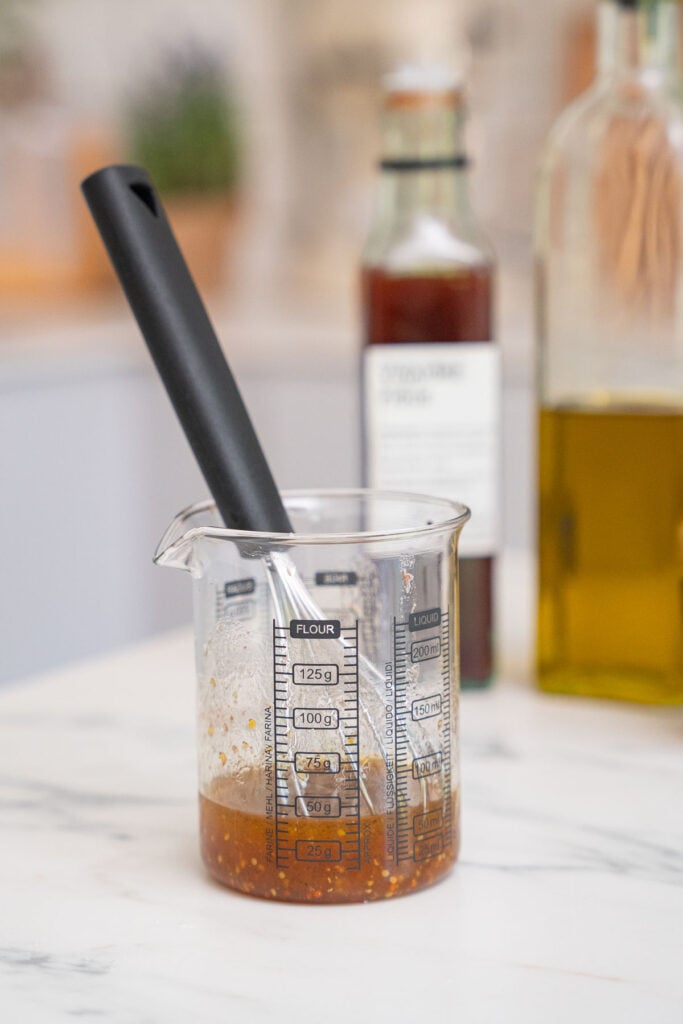 A glass of fig and honey vinegar vinaigrette