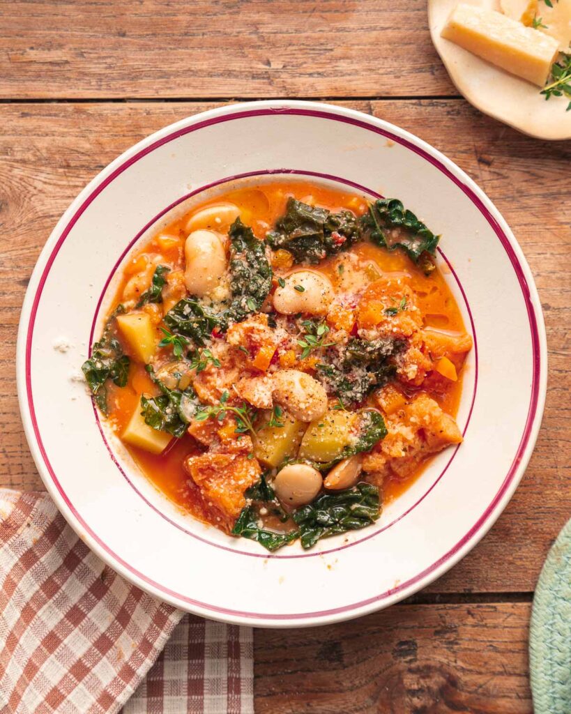 A bowl of ribollita, the Tuscan lacinato kale soup, with white beans, potatoes, and grated Parmesan